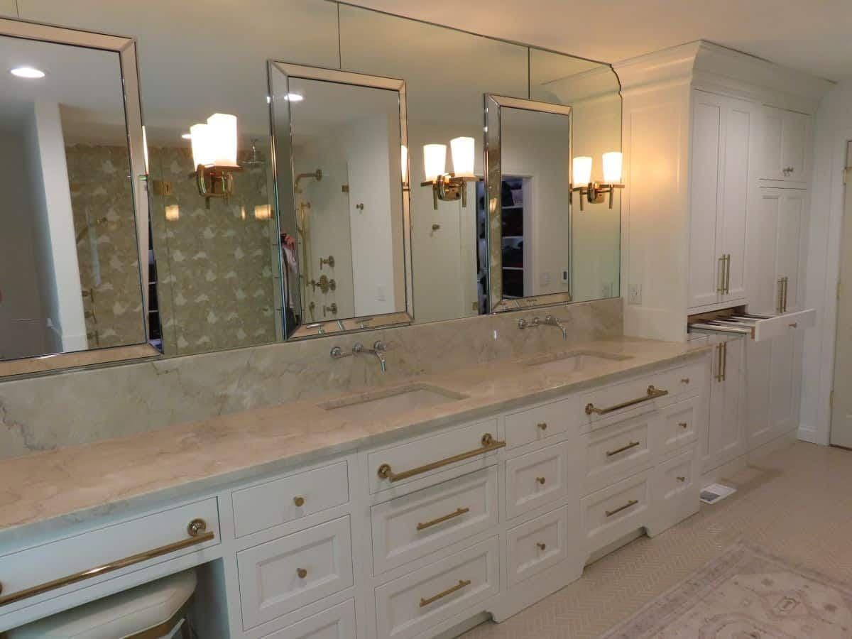 White painted double vanity with marble countertop, brass hardware and framed mirrors
