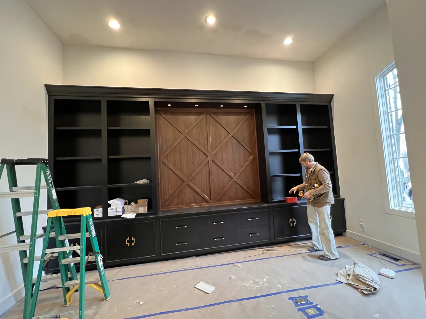 Black media wall going in, with the lattice panel set in place