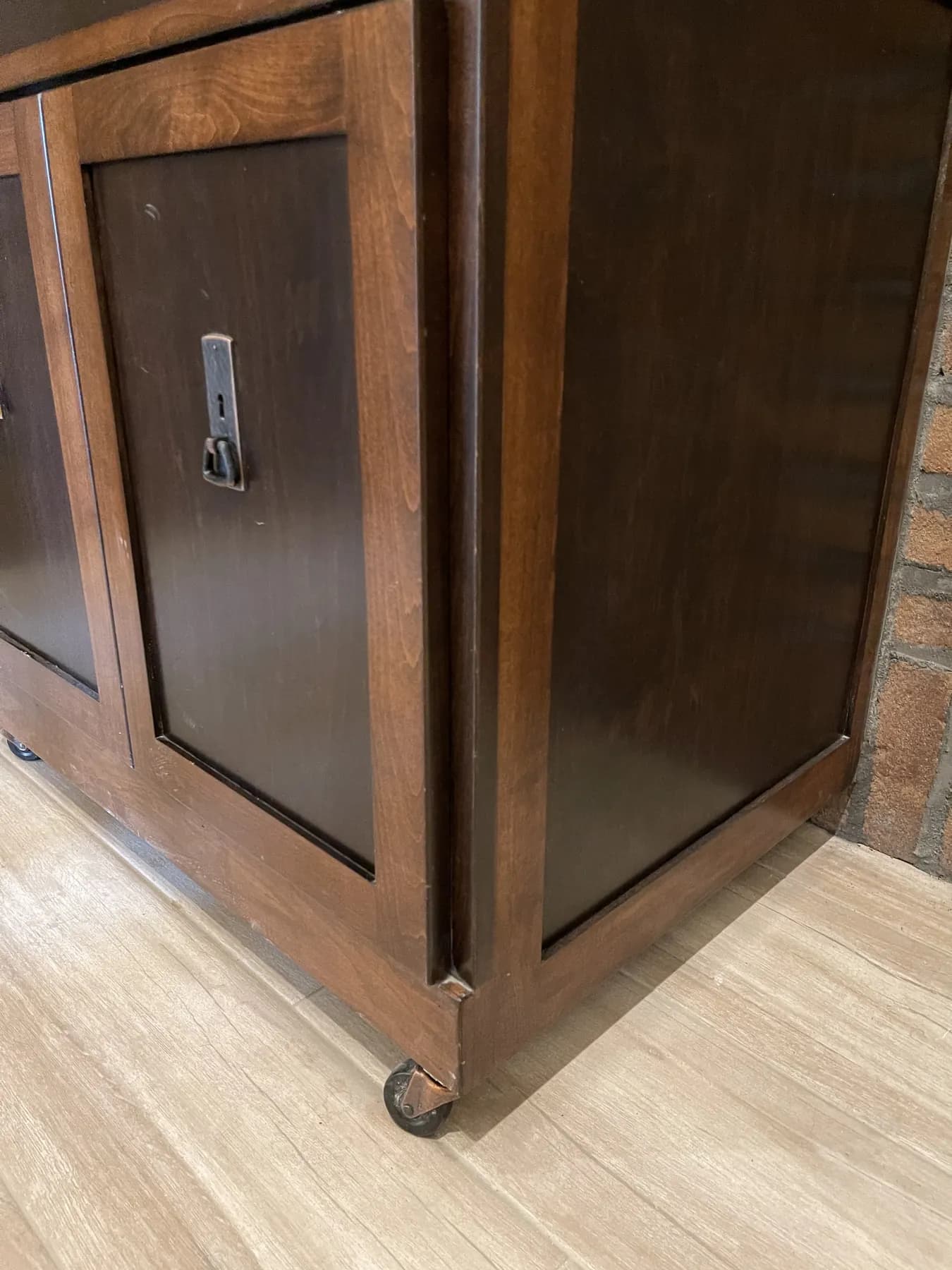 Stained cabinet on casters with a recessed pull