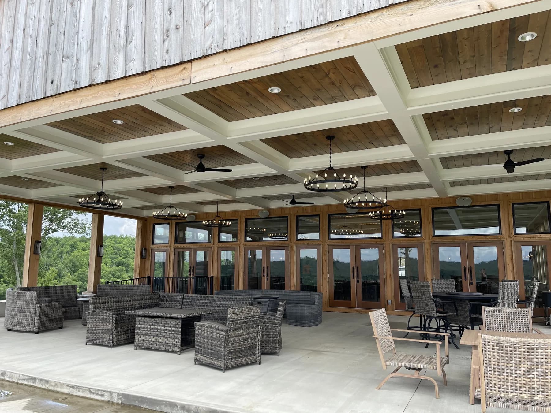 Coffered porch ceiling in stained plank over a lakeside terrace