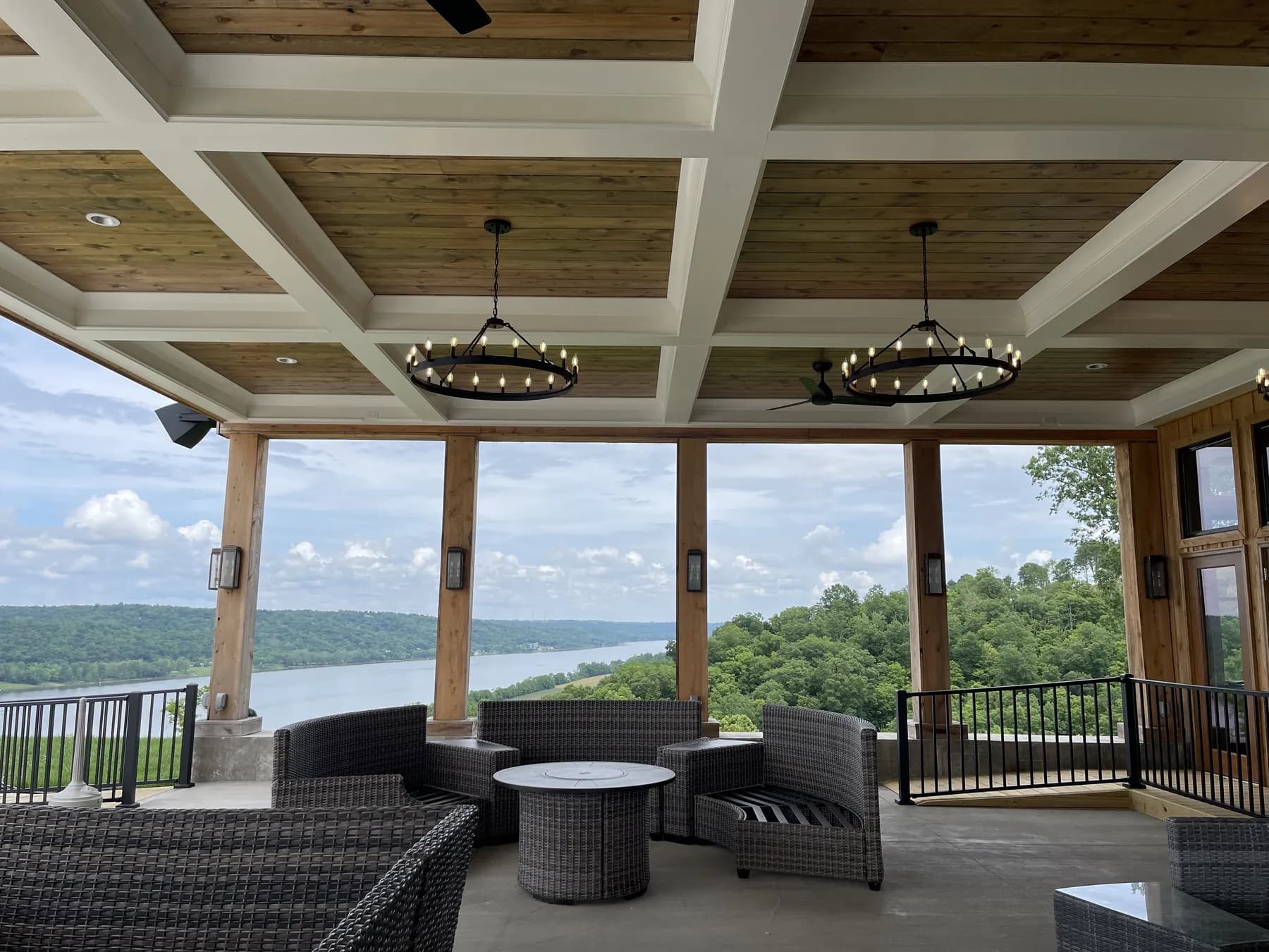 Coffered ceiling and iron chandeliers above the covered terrace