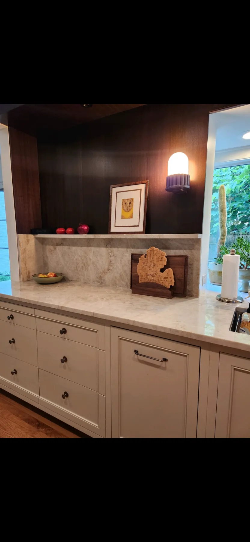 Painted counter run with a marble ledge and framed art