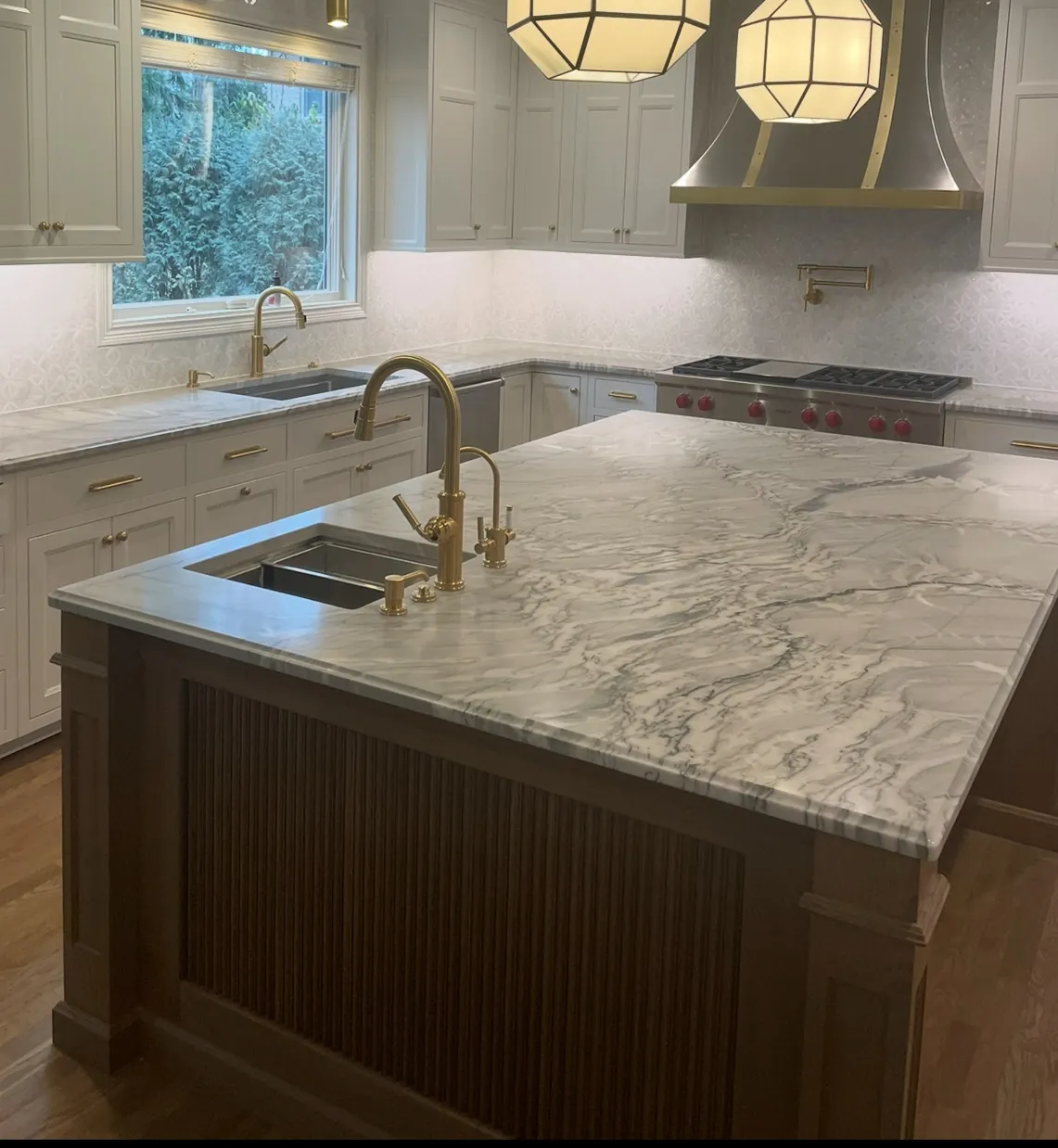 Stained island with a beadboard end panel and a thick marble top