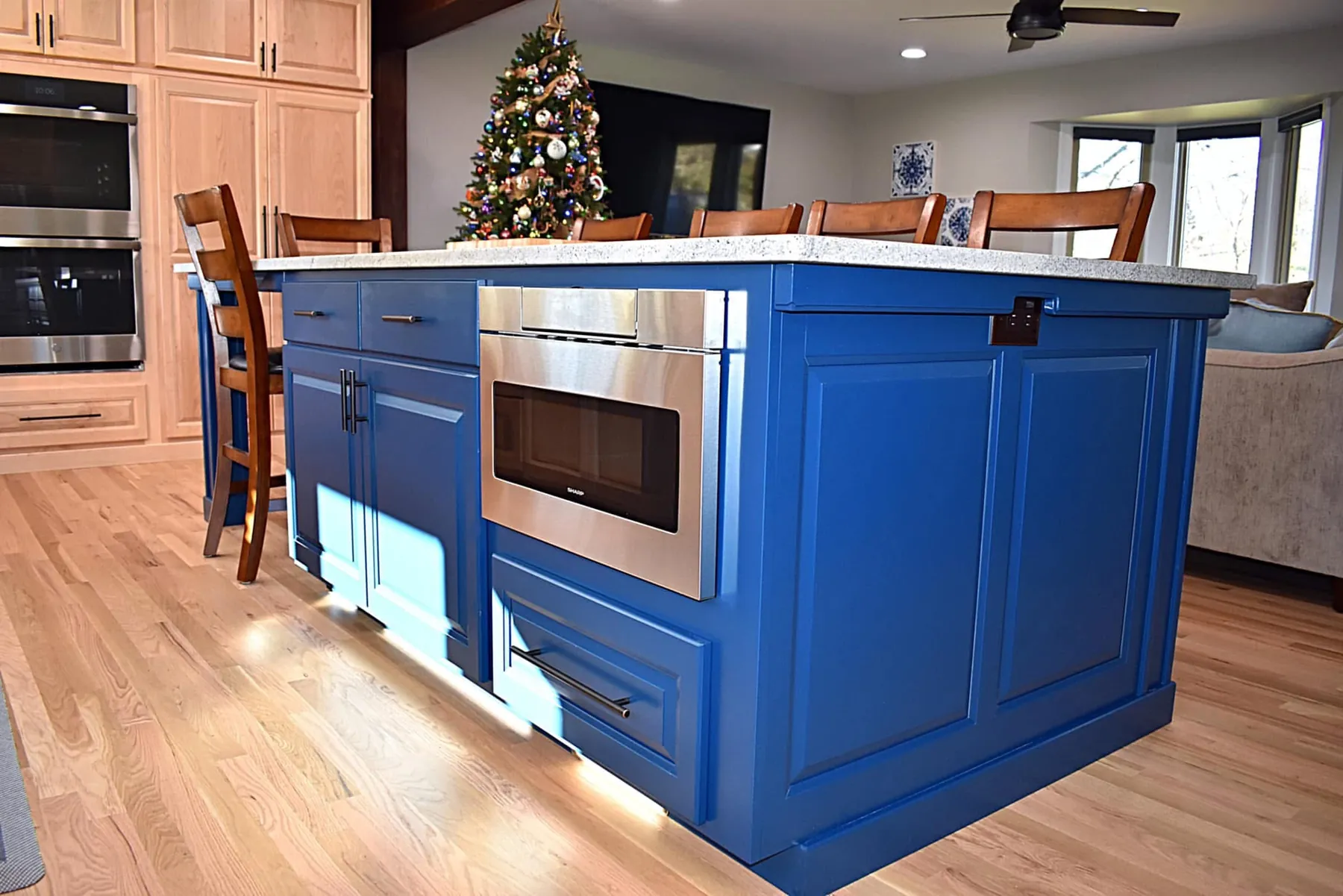 Navy island with a microwave drawer and a seating overhang