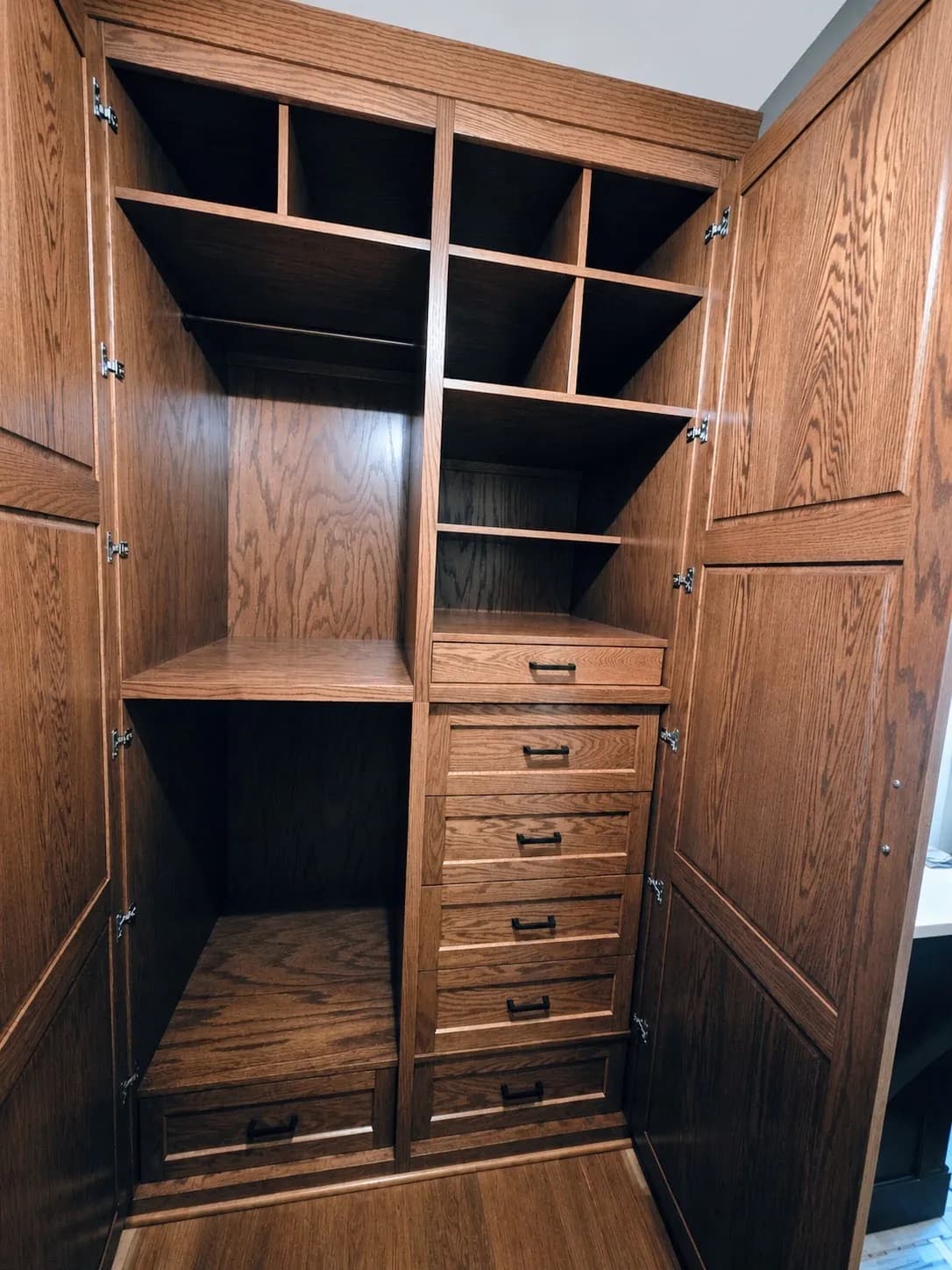 Oak wardrobe interior fitted with cubbies, shelves and drawers