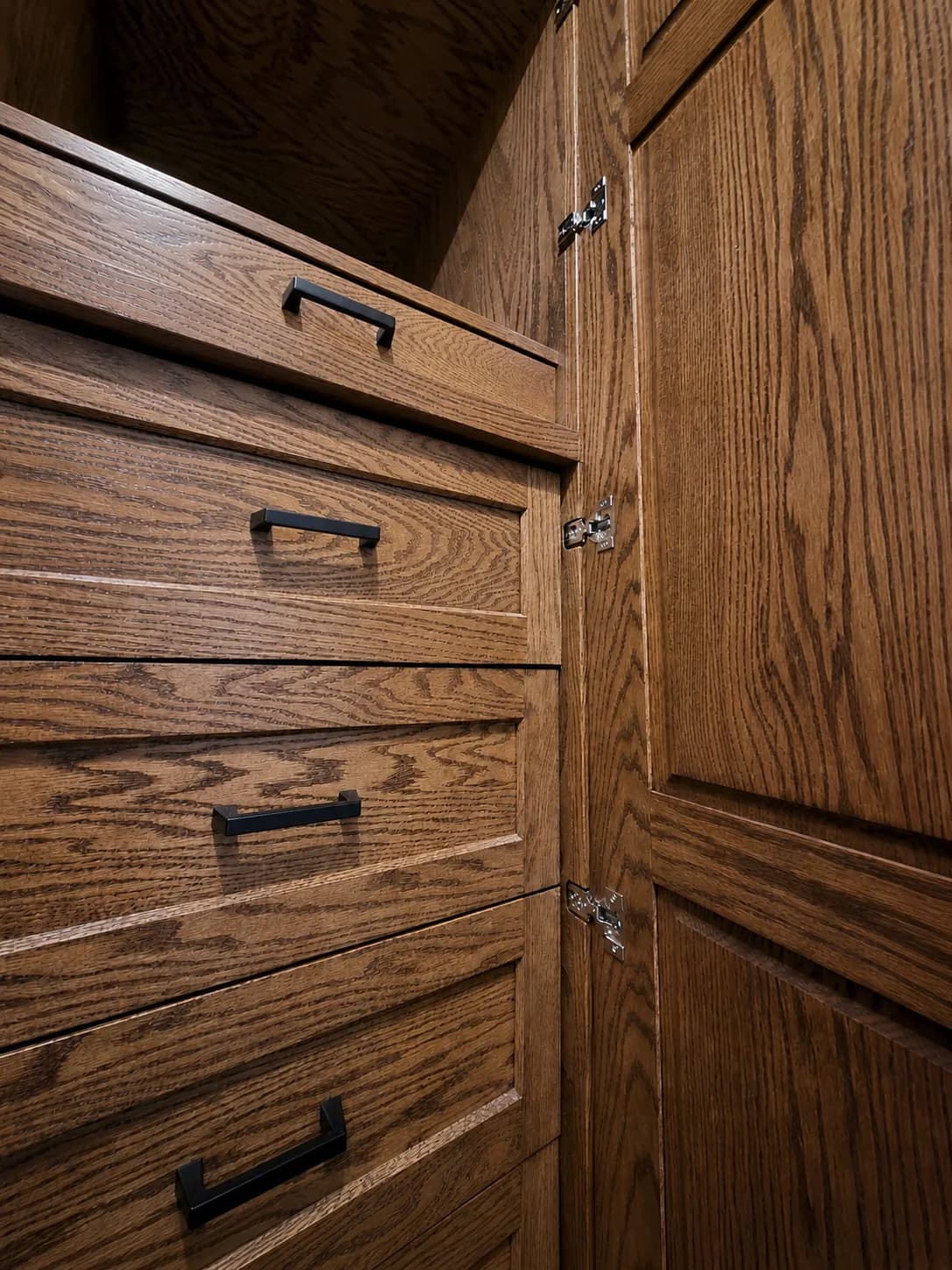 Detail of oak drawer fronts and bronze bar pulls