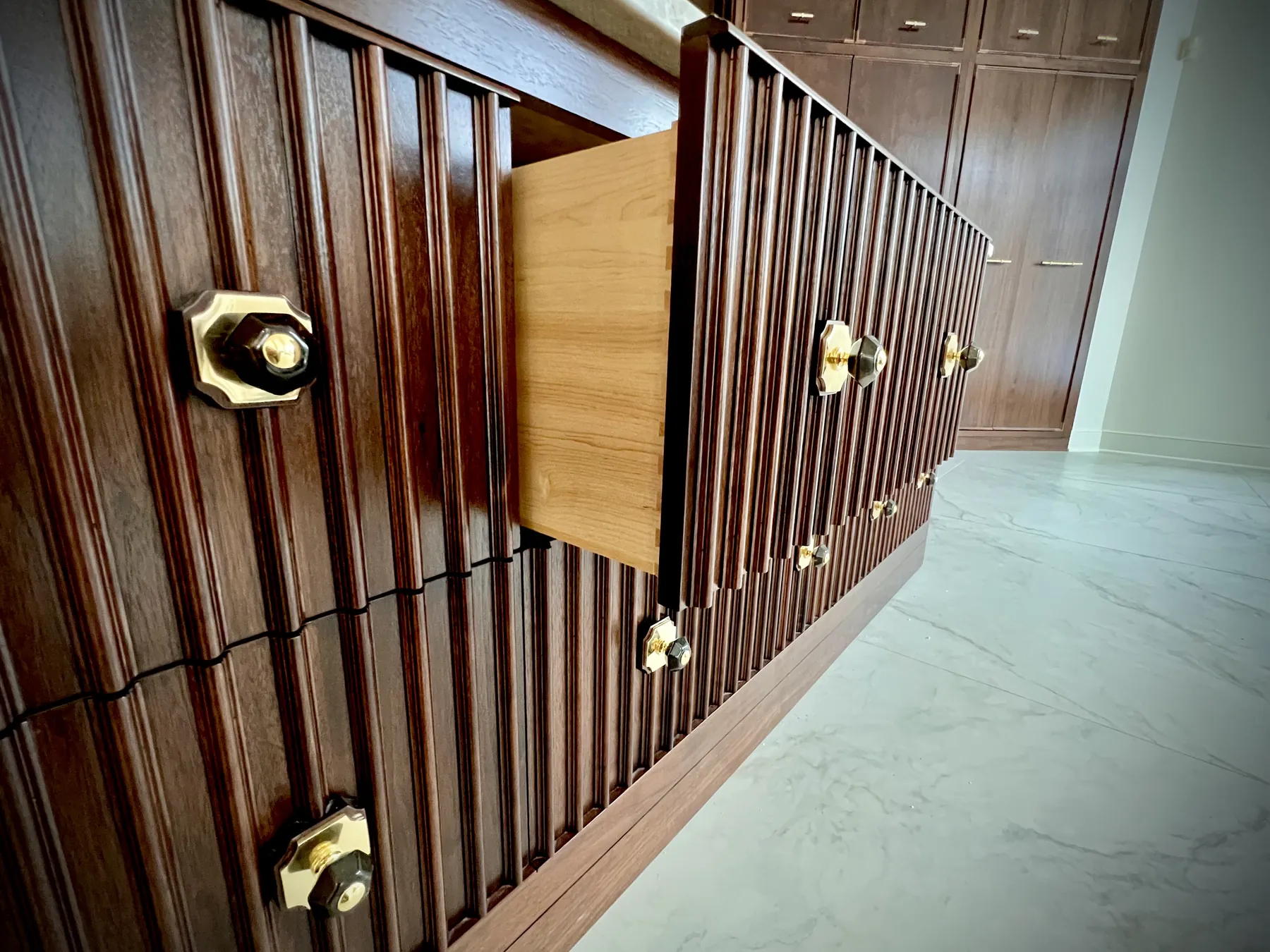 Pull-out breadboard extending from the reeded walnut island