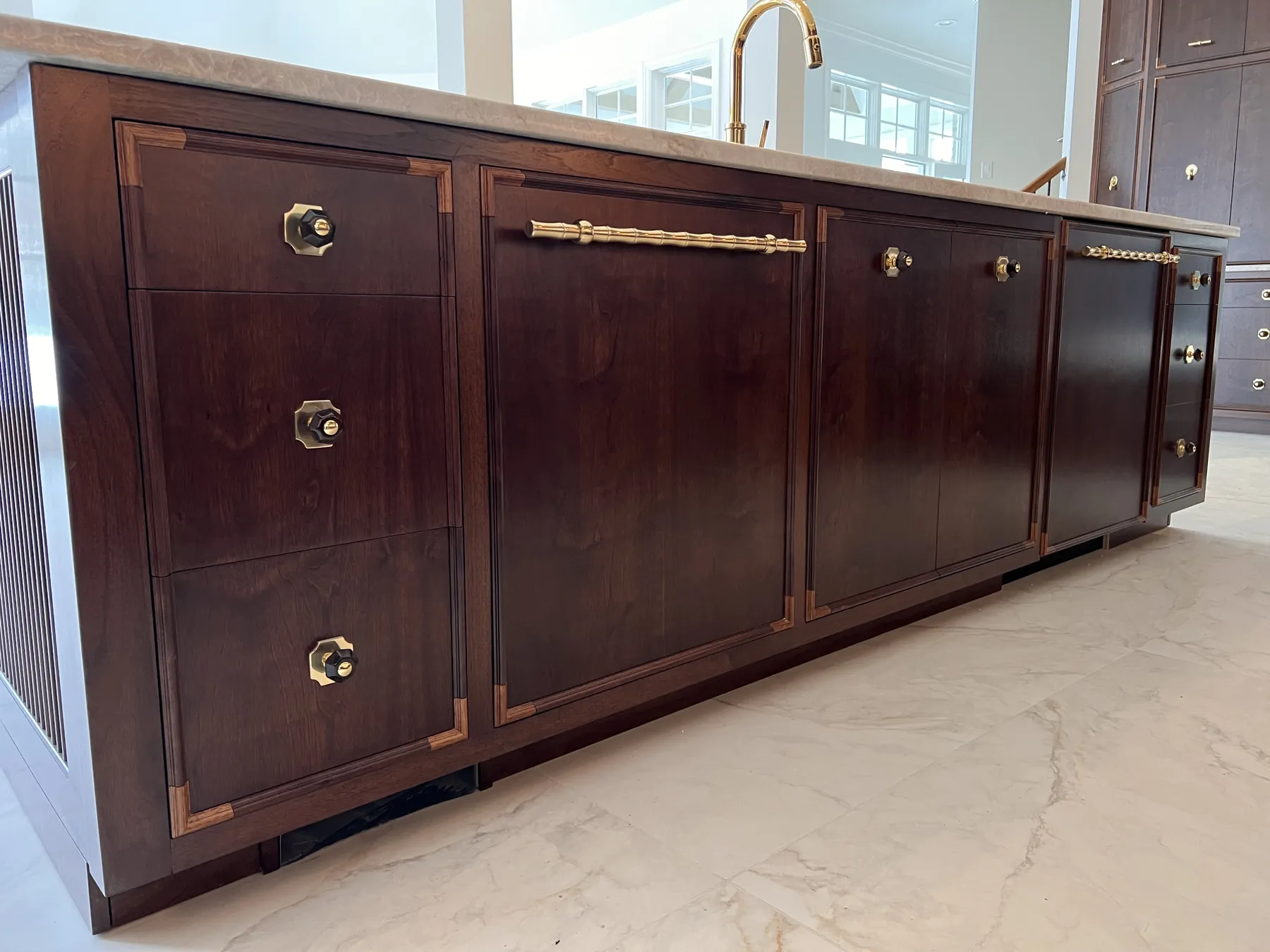 Walnut sideboard with brass hinges and inlaid banding along the drawer fronts