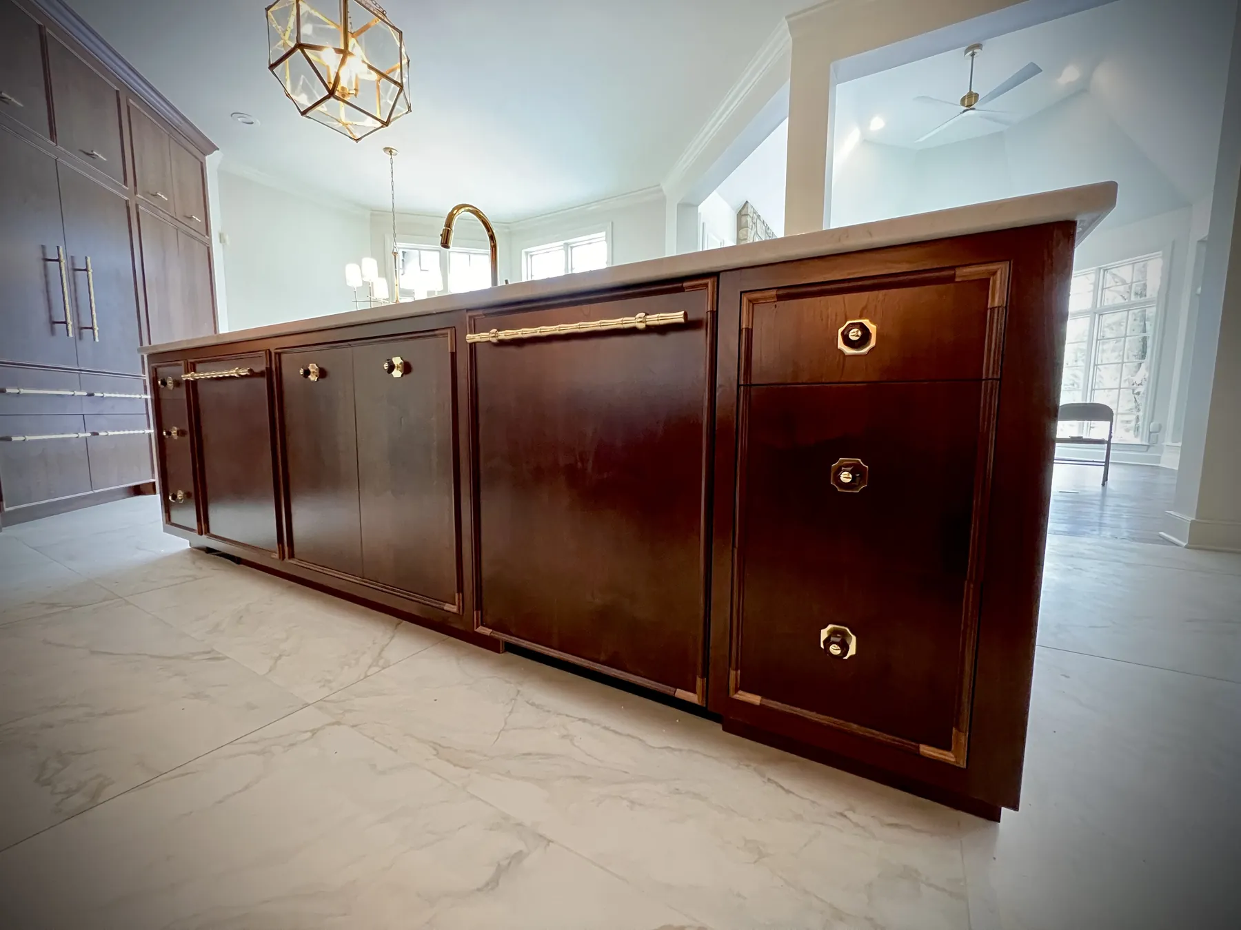 Long walnut sideboard with brass bar pulls and inlaid banding