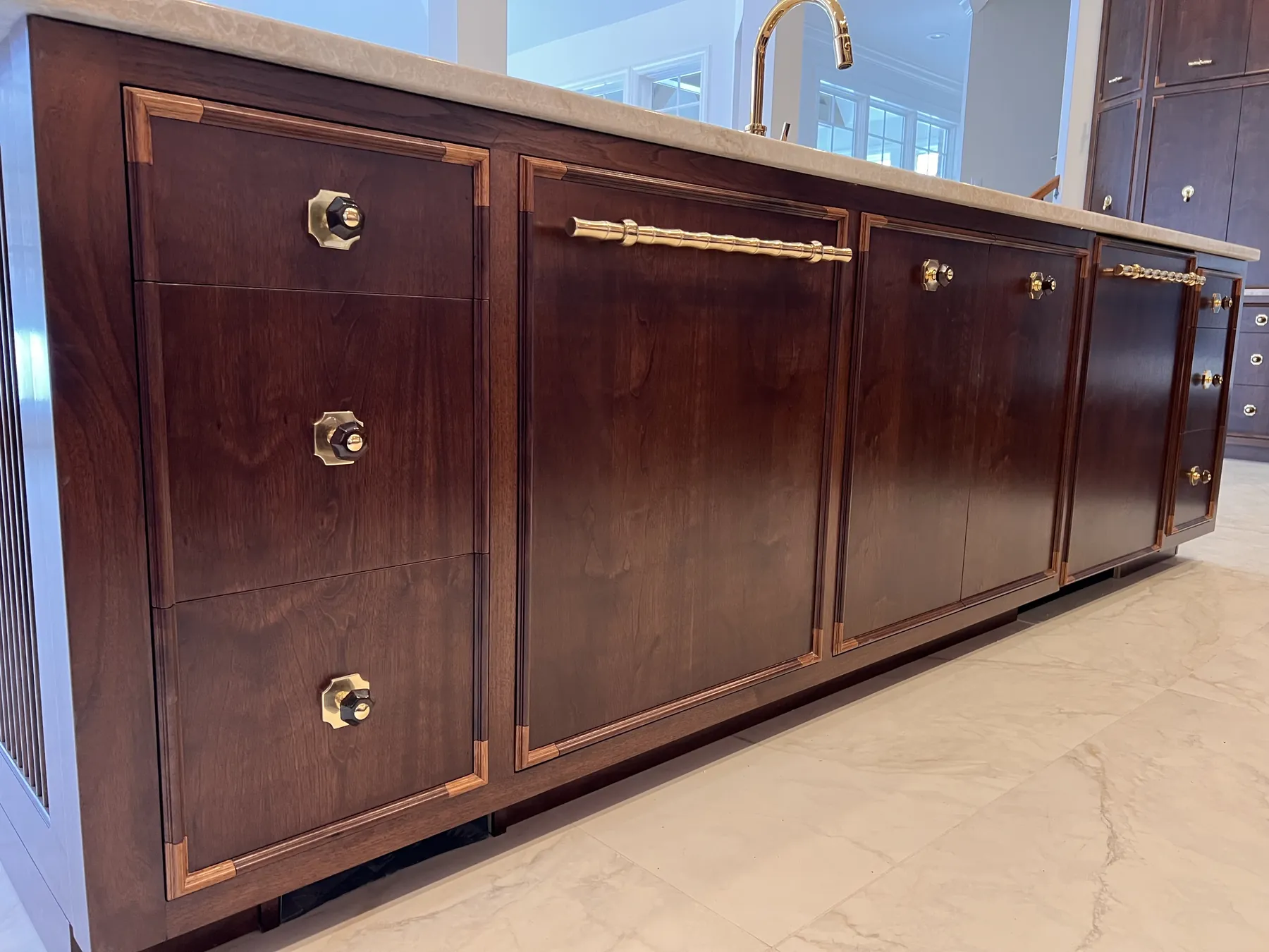 Walnut cabinet doors with brass pulls and banded inlay
