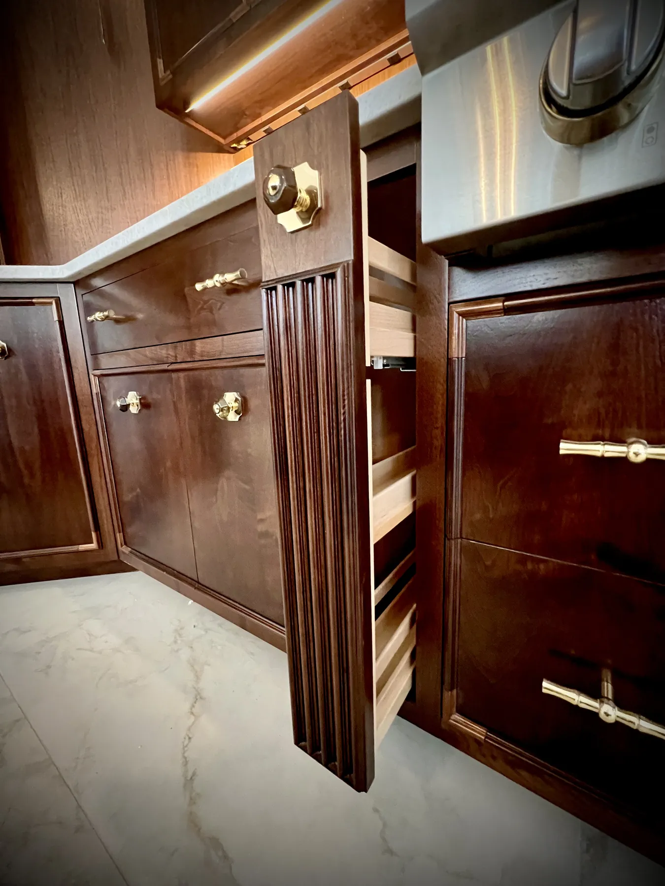 Pull-out storage and drawer banks opened inside the walnut pantry