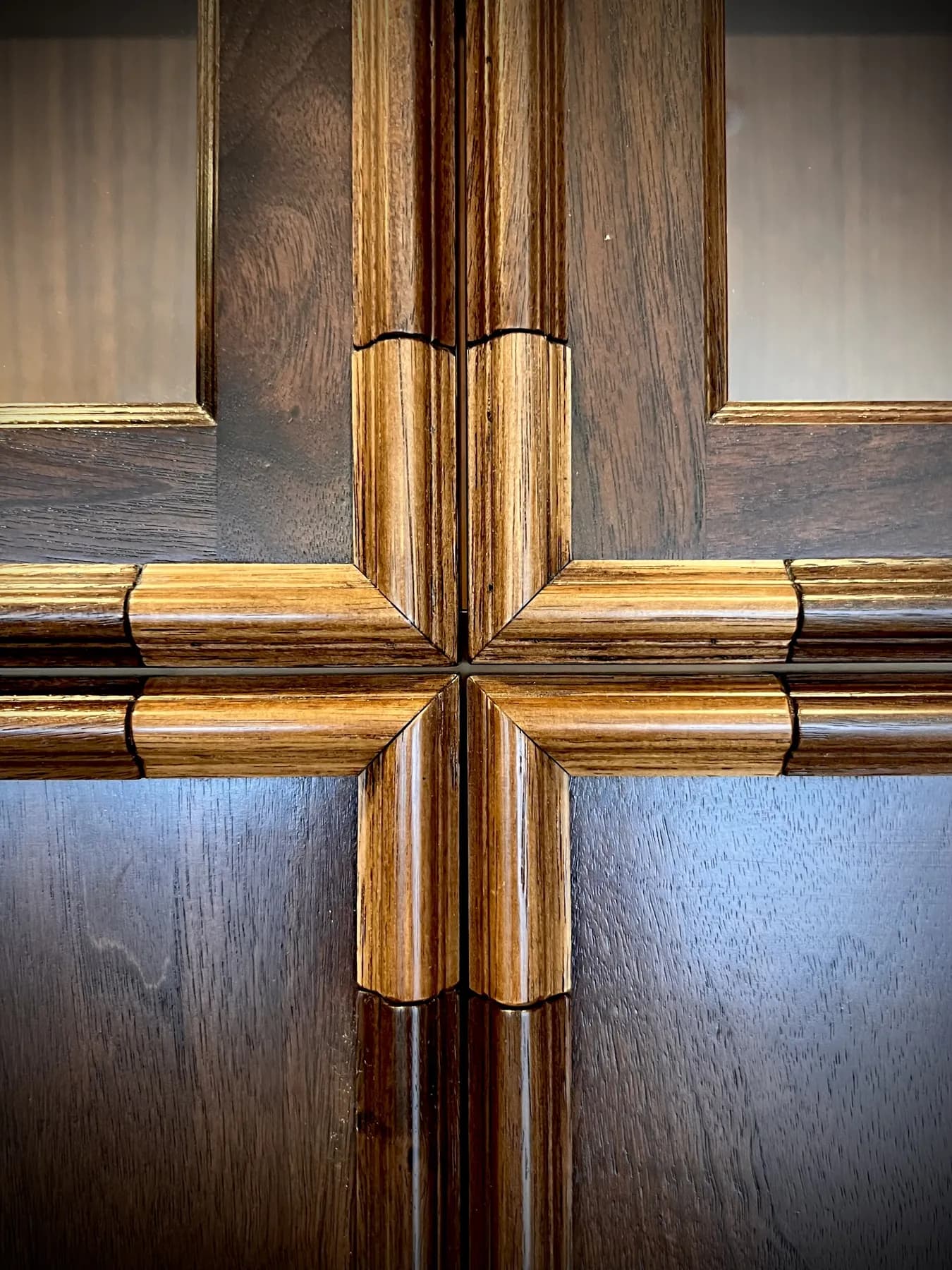 Detail of the gilded cross inlay on a walnut door