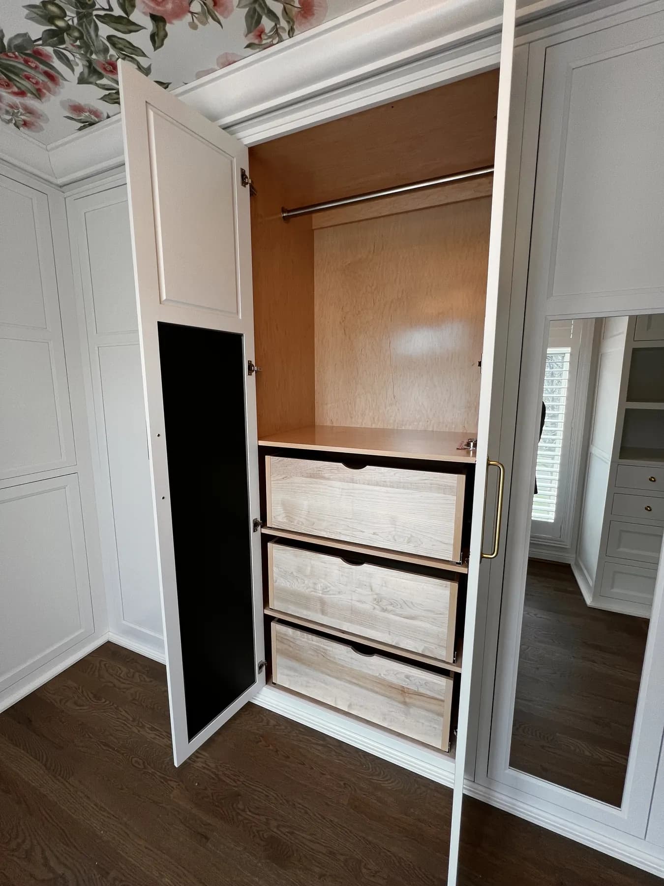 Painted closet interior with a wall safe and stacked drawers