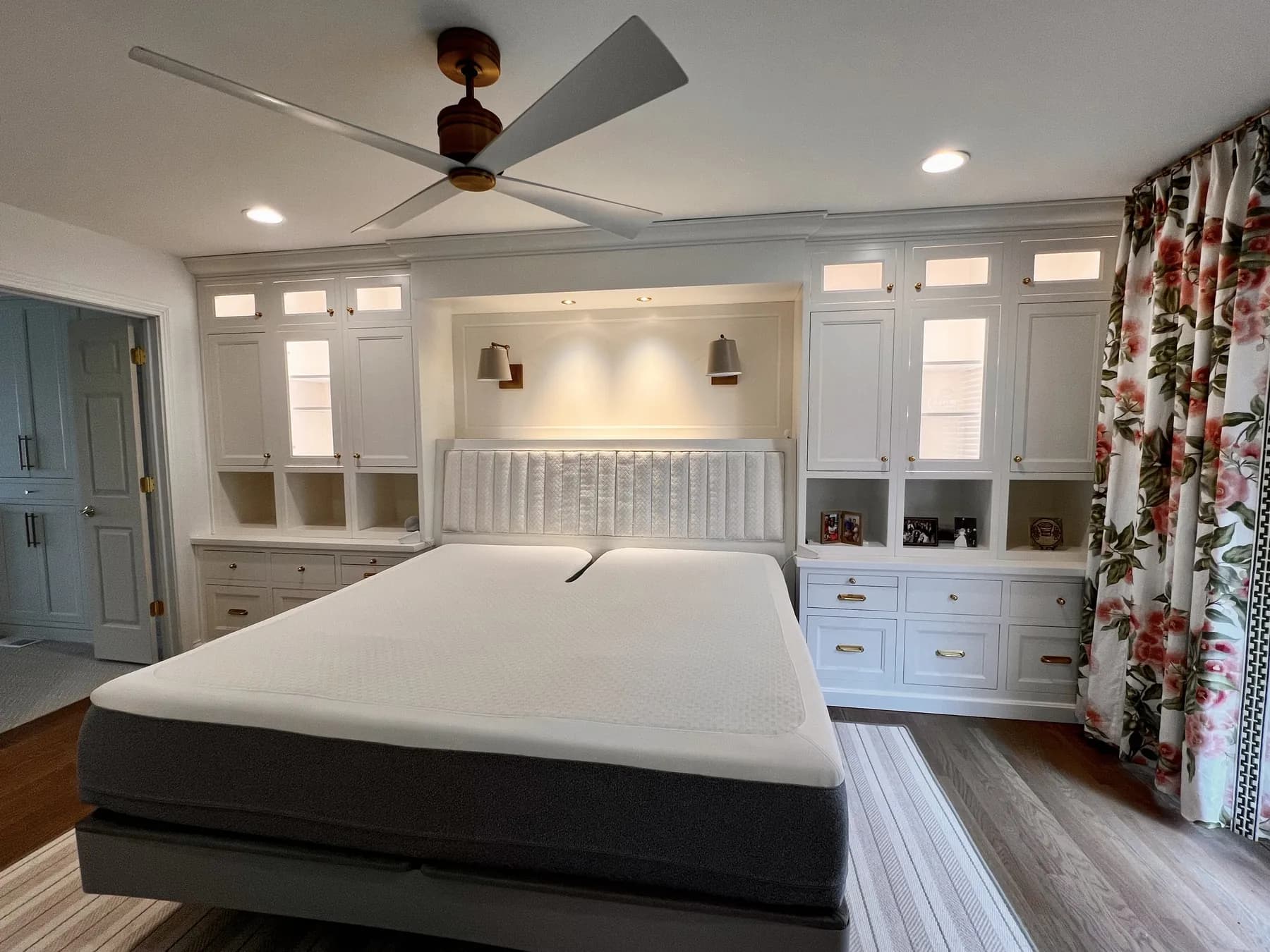Bedroom wall of painted cabinetry framing an upholstered bed